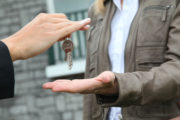 Agent handing keys to buyer – Reasons to purchase real estate in off season