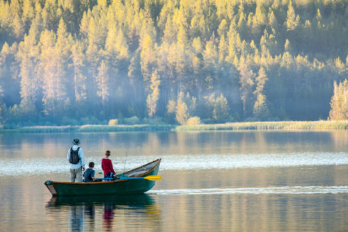family in fishing boat, lake, trees, ldaho, best places to live