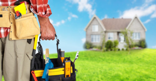 Handyman with tool bucket, house, rental property, home improvement