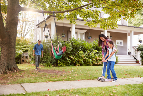 Happy family playing in front yard – Idaho rates high a great place to raise family