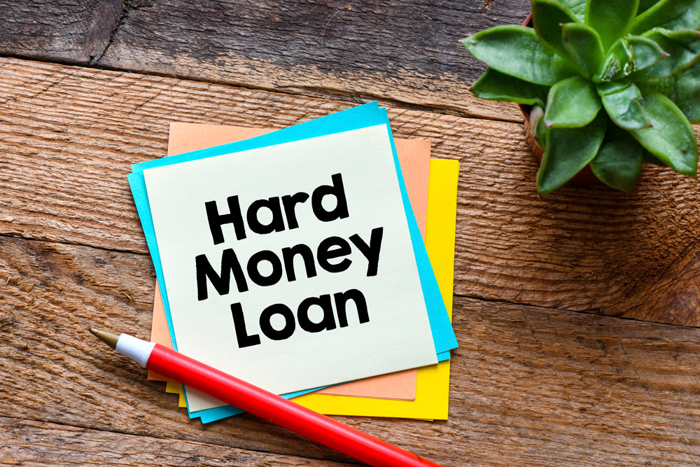 hard money loan written on notepad, pen, desk
