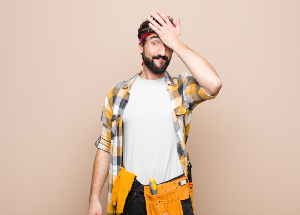 man wearing repair belt making face, home repairs