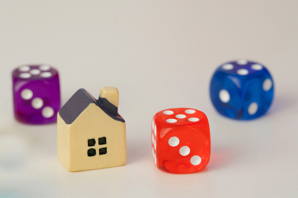 toy house, dice, real estate investing