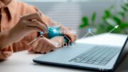 person analyzing real estate trends, laptop