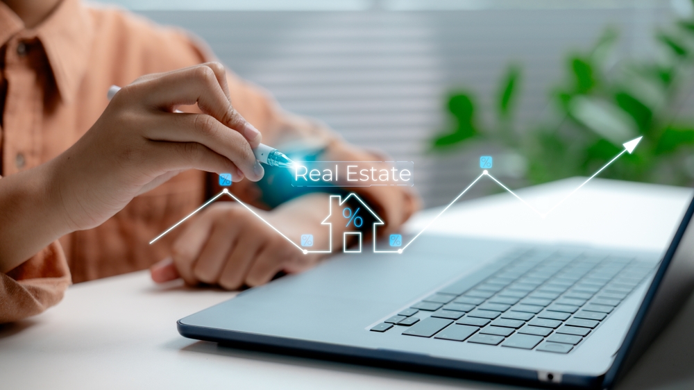 person analyzing real estate trends, laptop