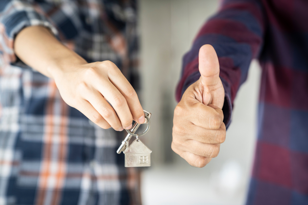 person holding house key ring, person thumbs up, real estate