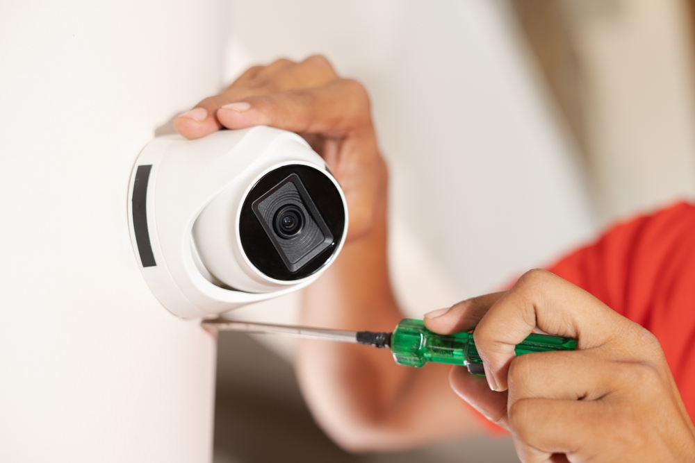 homeowner, landlord installing security camera, home safety