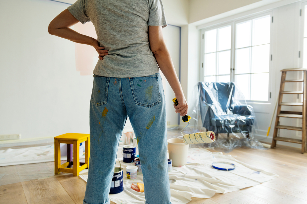 woman with paint roller, painting room, home renovation